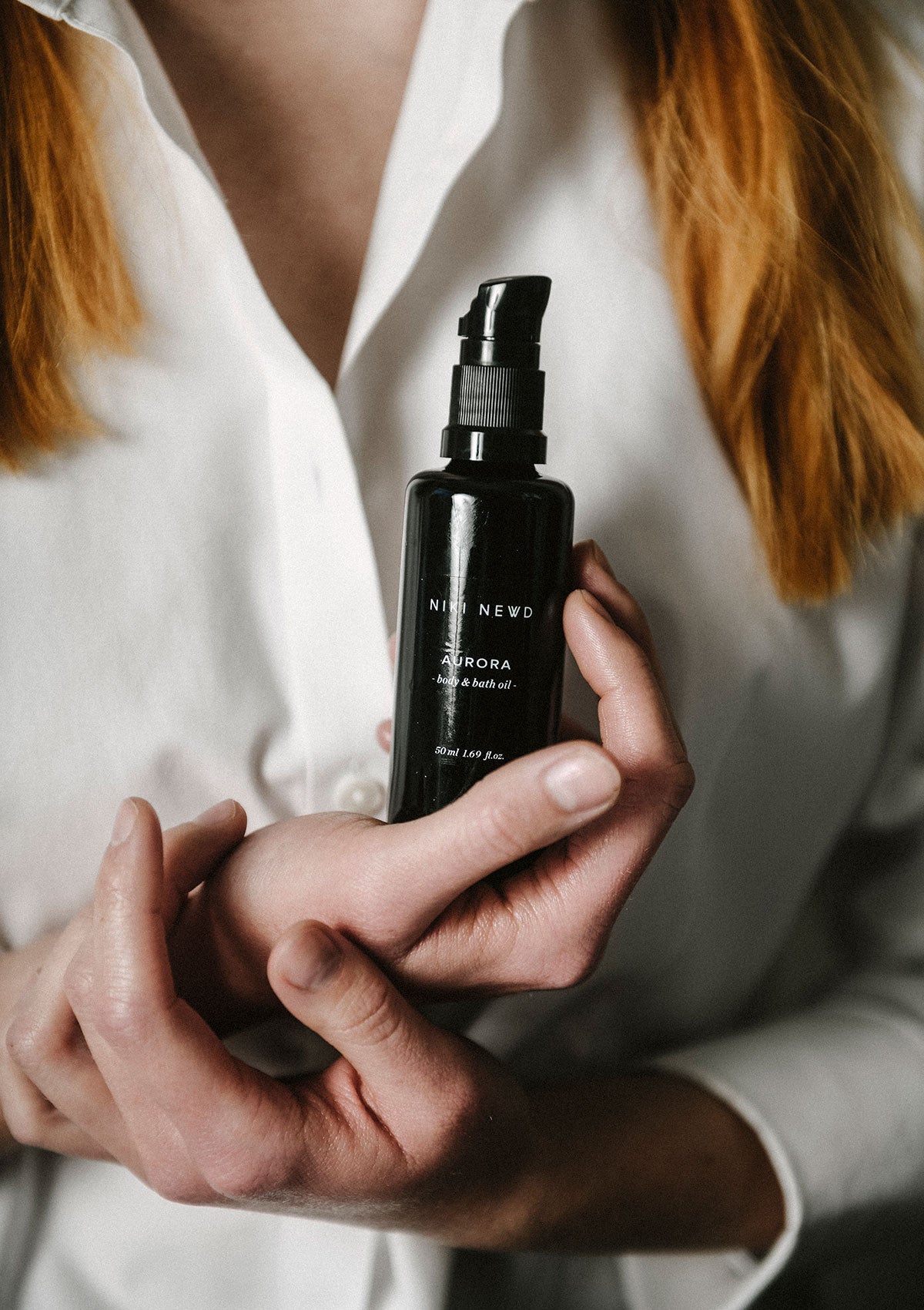 Get glowing skin with Niki Newd® Aurora – a luxurious body oil that smooths and enhances natural radiance.