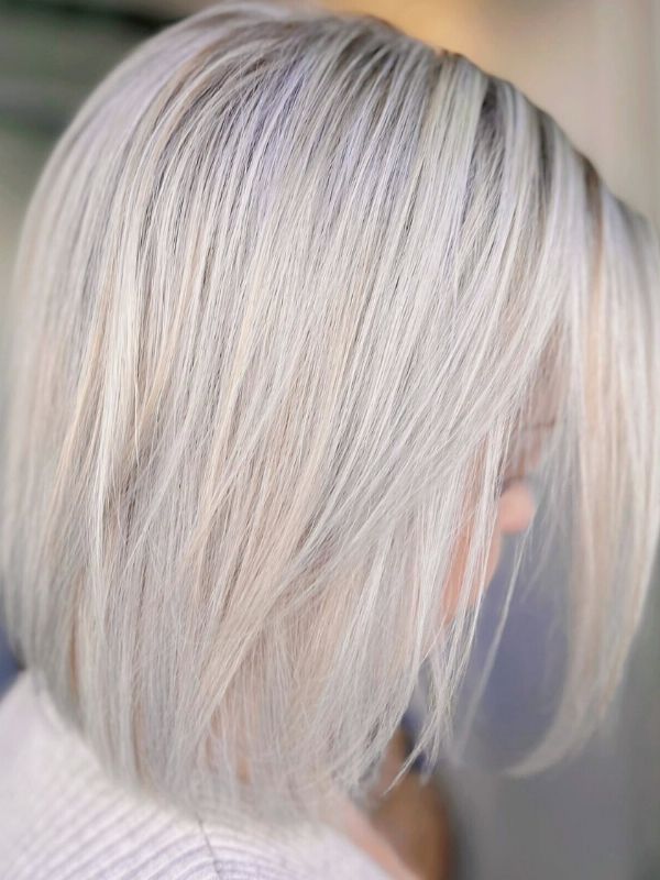 Mid-length Platinum Blonde hair created at Niki Newd® Hair Studio – soft, luminous color with a natural, modern finish.