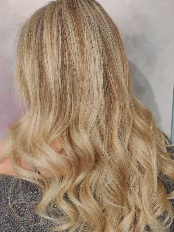 Long hair with natural sun-kissed highlights created by Hair Studio Niki Newd® — a soft, radiant blonde look with a fresh, luminous finish.